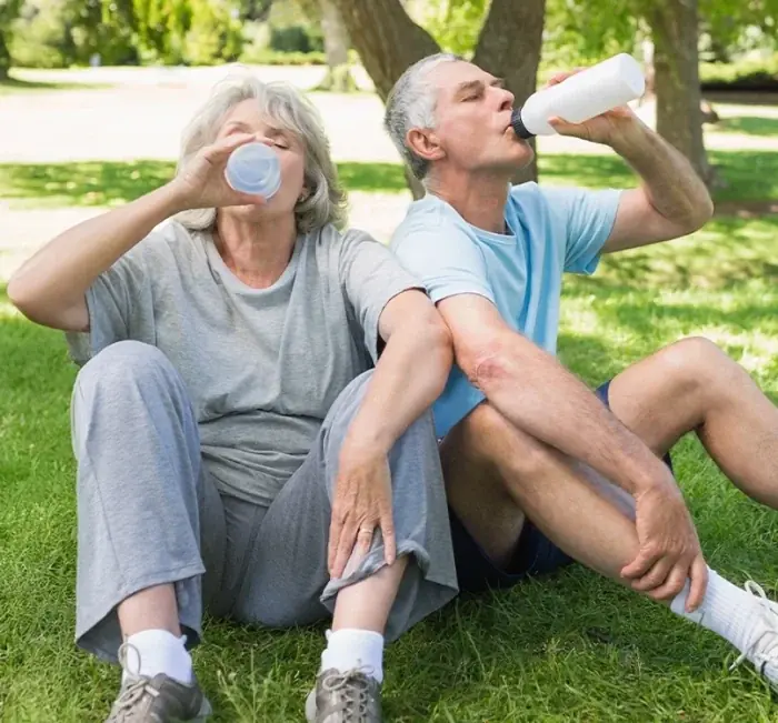 Mature couple resting in a park after exercise